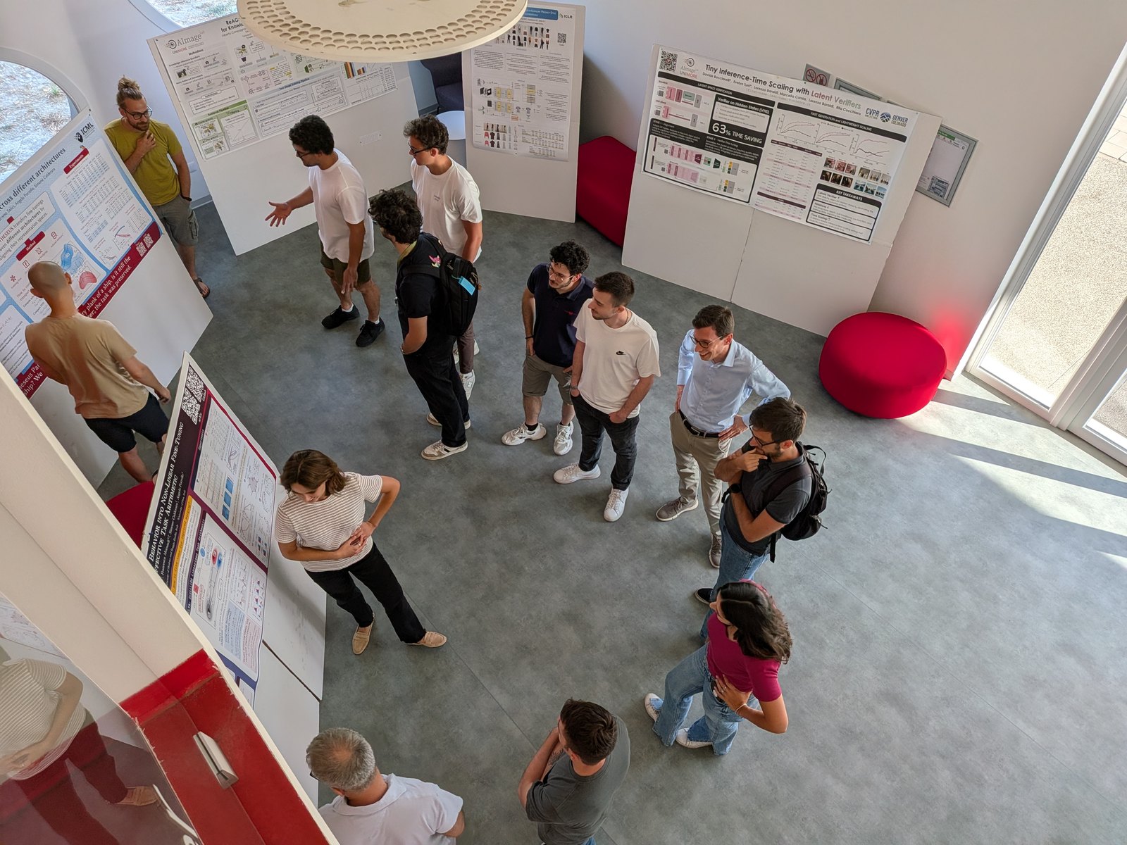 Participants discussing posters at the ELLIS ICML Fest 2026, seen from above