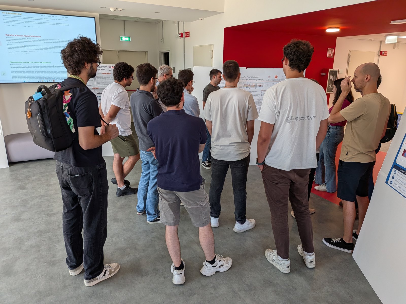 A group of researchers gathered around a poster